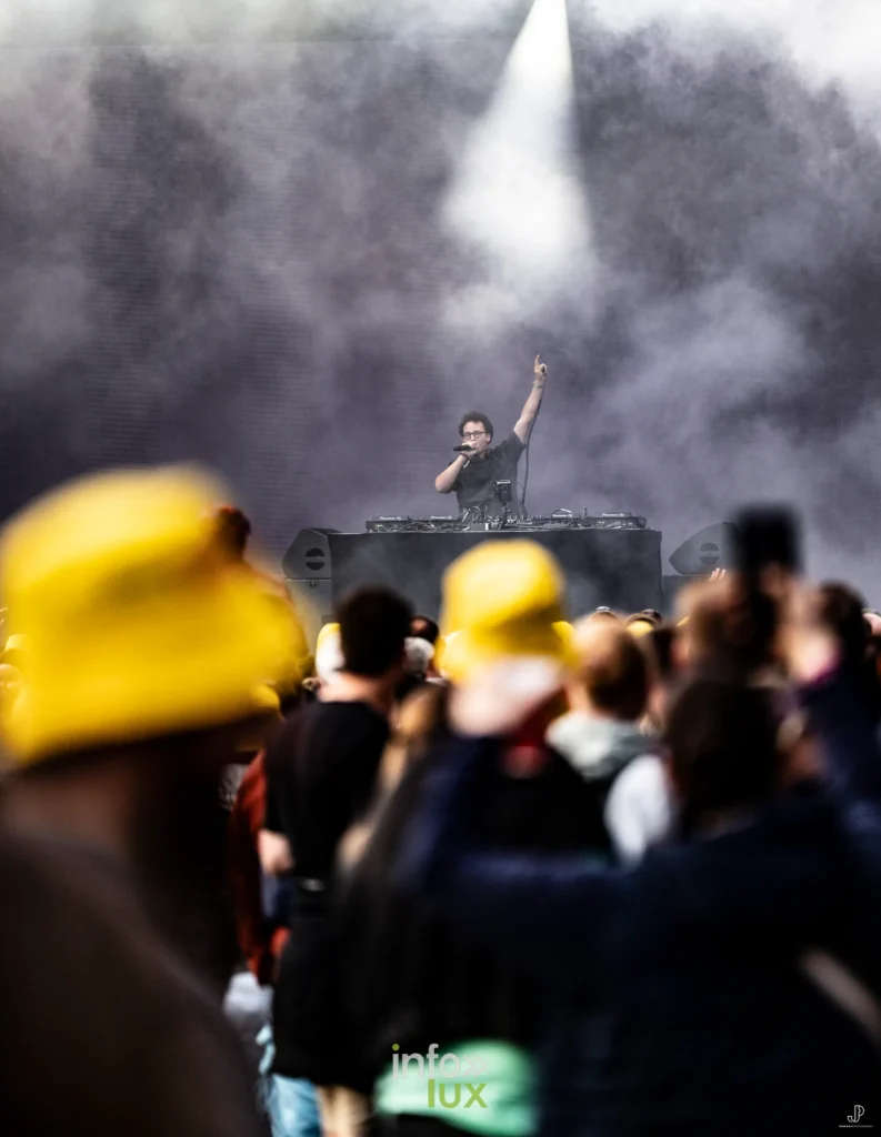 Le public de dos, plusieurs festivaliers coiffés de bobs jaunes, devant la scène
