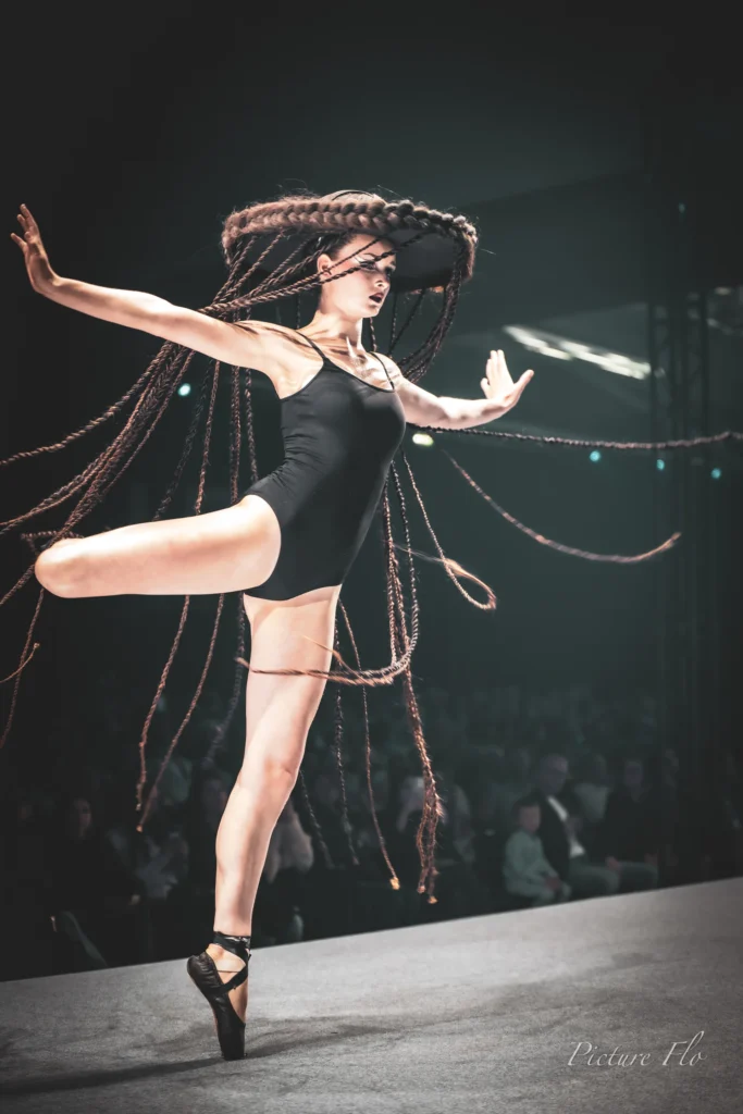 Léa en arabesque sur le podium, chapeau de tresses, Lux Fashion Week 2026, Arlon