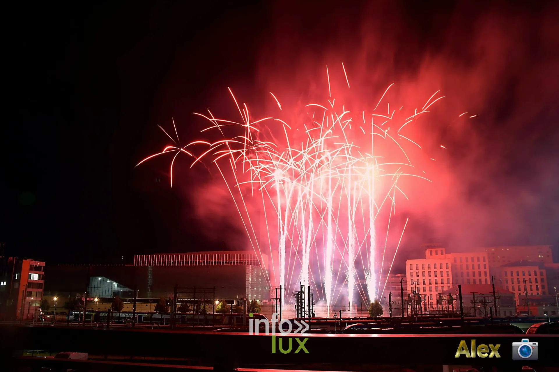 Feu d'artifice rouge au-dessus des toits