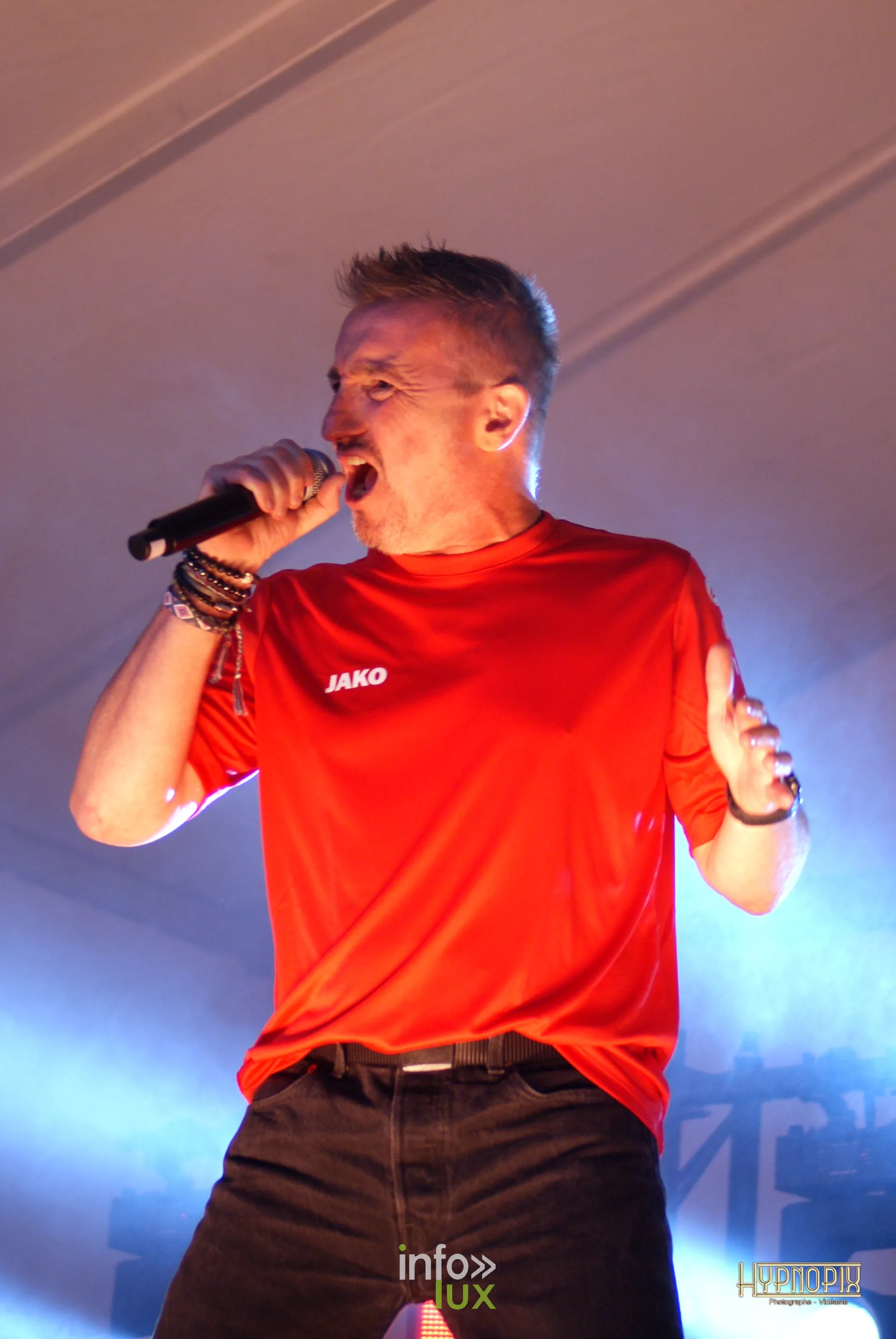 Chanteur en t-shirt rouge sur la scène de la Braderie de Braine-l’Alleud, 5 septembre 2026