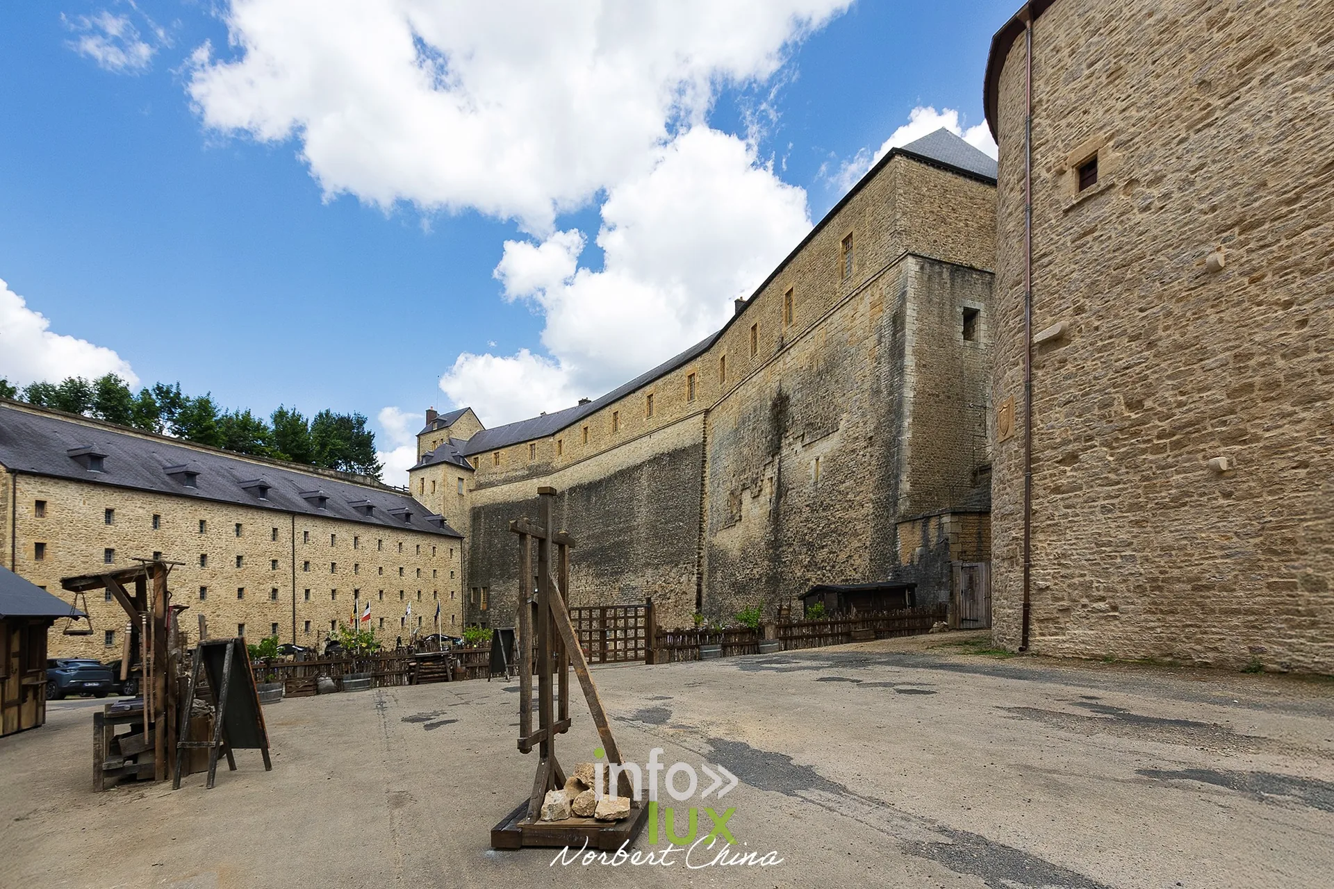 Cour du château fort de Sedan avec engin de siège en bois et longs bâtiments