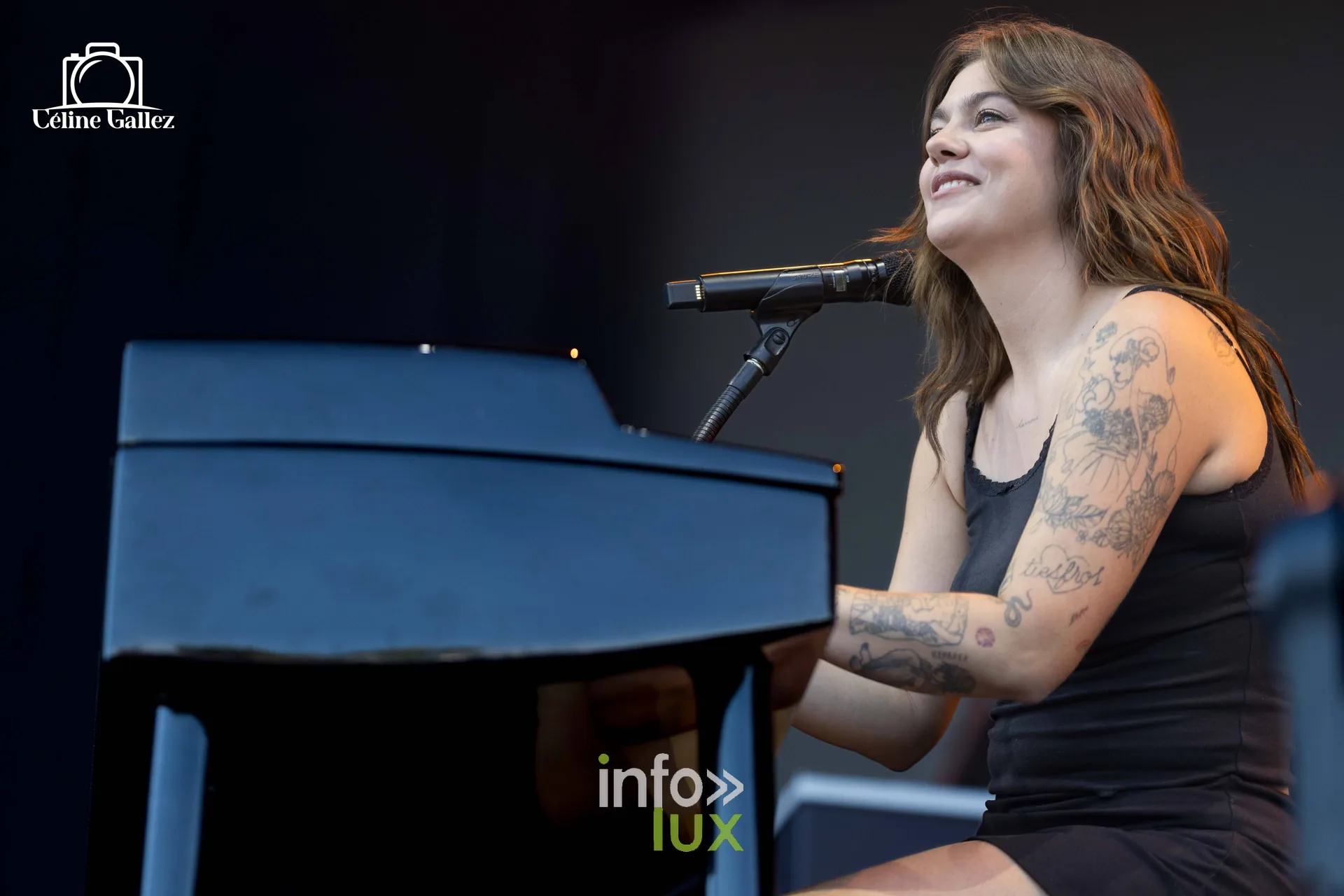 Louane assise au piano sur la grande scène