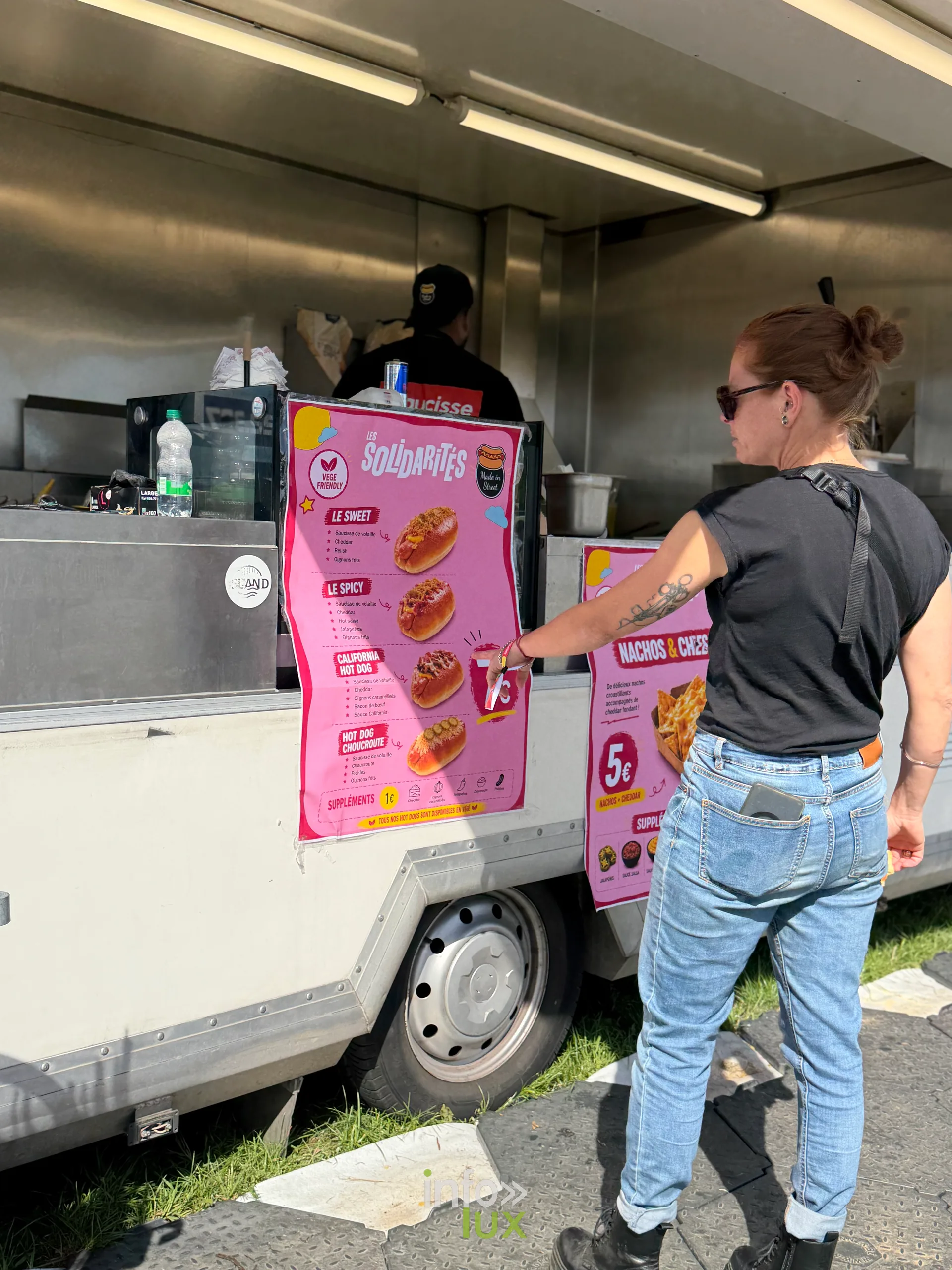 Une festivalière commande devant un food truck