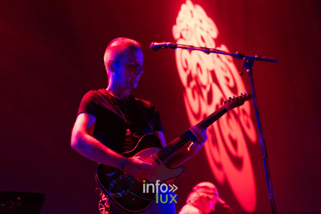 Guitariste de Girls in Hawaii devant le decor lumineux du festival