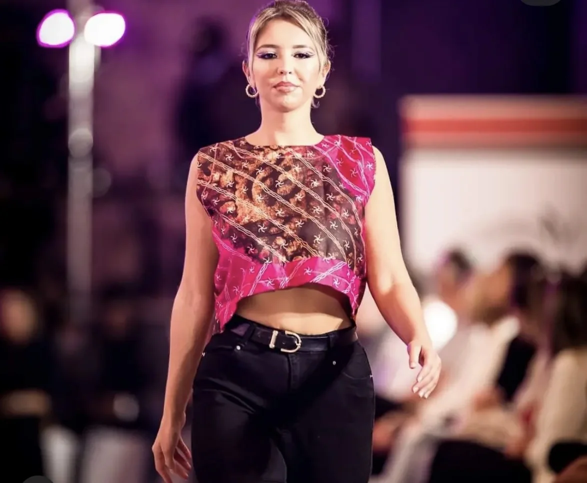 Mannequin en top rose à motifs sur le podium de la Liège Fashion Week