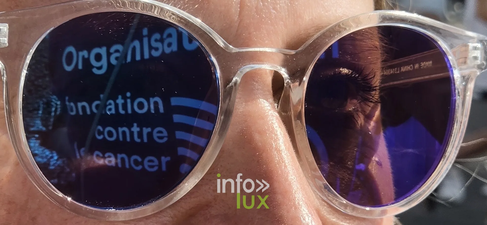 Logo « Organisation Fondation contre le Cancer » reflété dans des lunettes, Relais pour la Vie de Nivelles 2026
