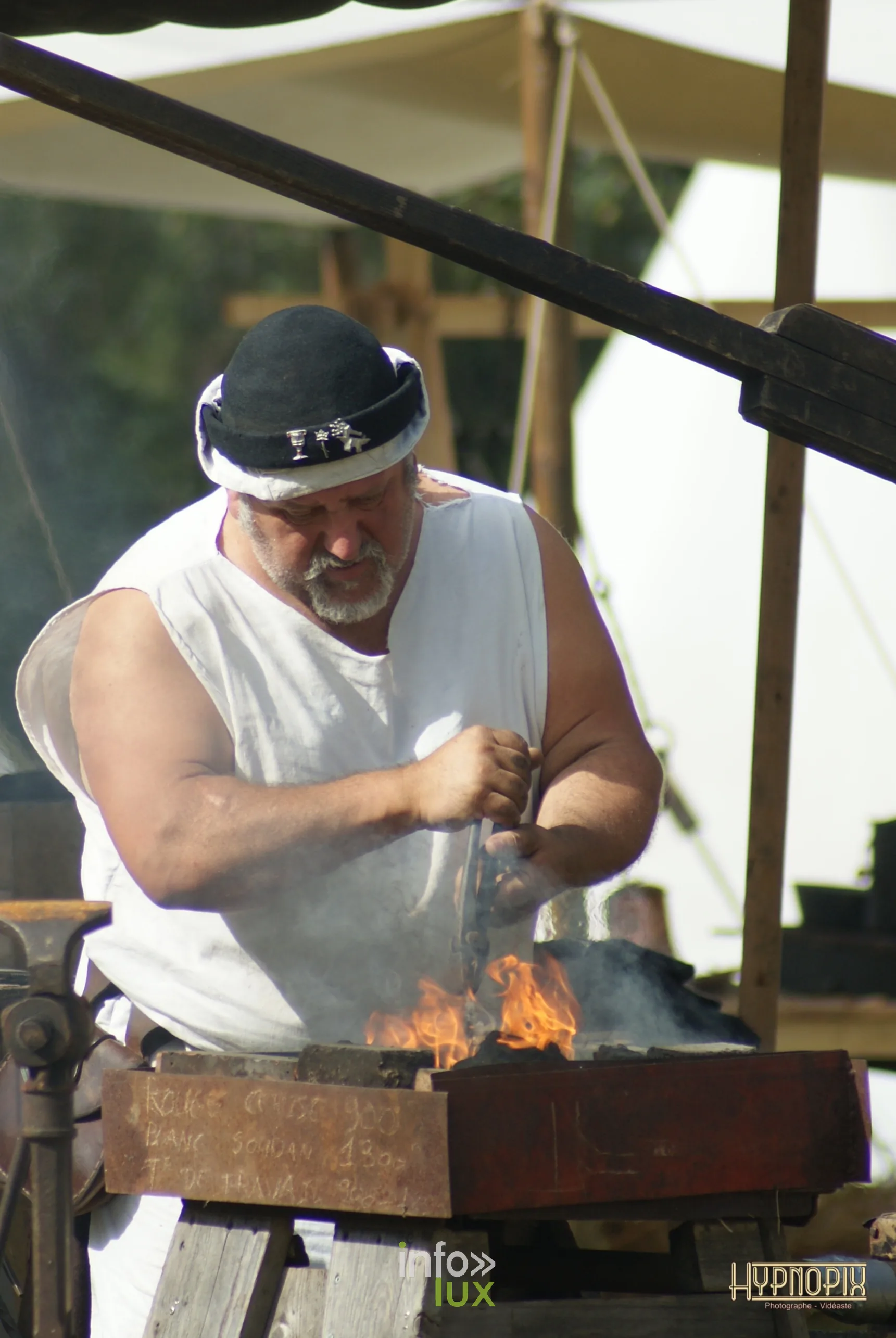 Artisan attisant le feu d’une forge aux Rencontres Médiévales de Braine-le-Château 2026