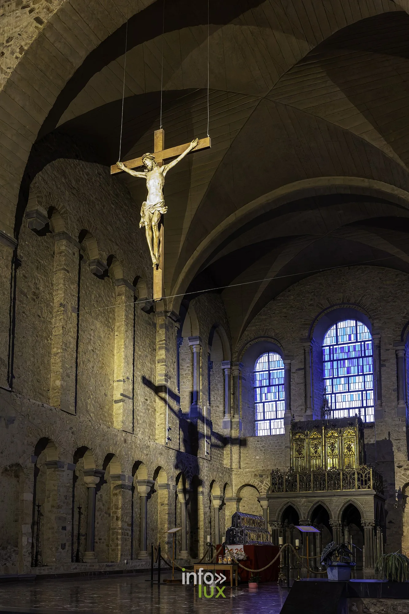 Le grand crucifix suspendu dans le transept de la collégiale, devant les vitraux