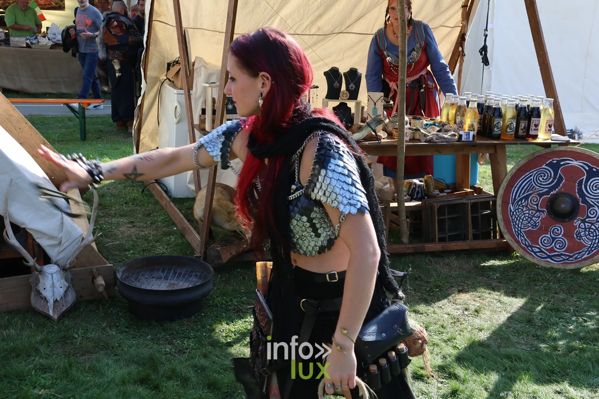 Guerrière en cotte de mailles et cheveux rouges devant un stand, Valhalla Days 2026