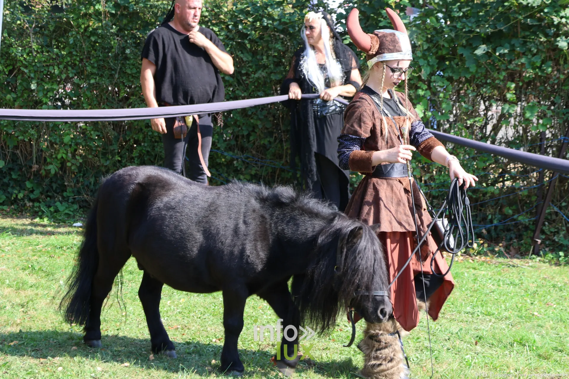 Poney noir mené par une cavalière en tenue viking, spectacle équestre à Ciney