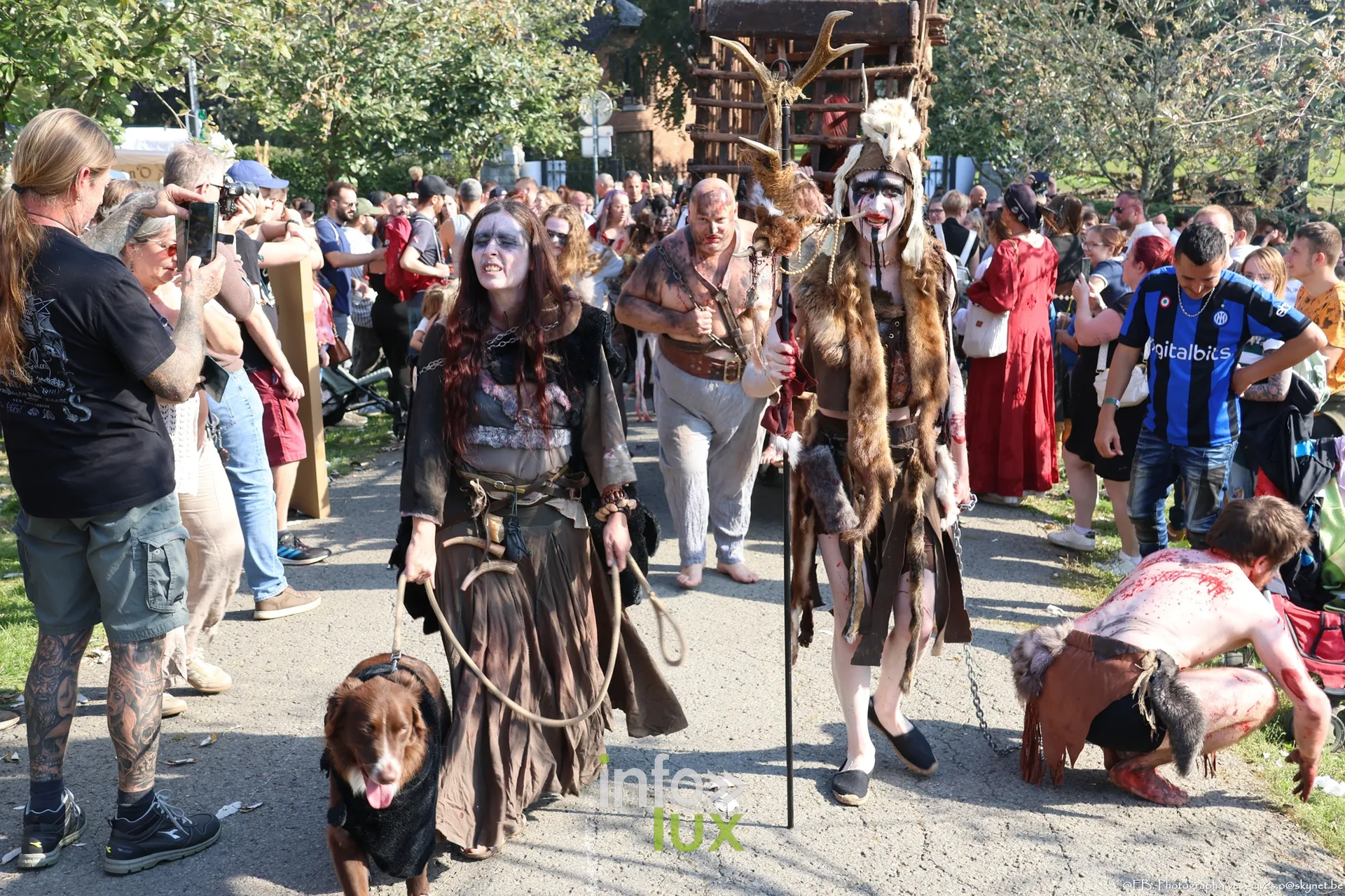 Cortège de figurants grimés et costumés dans les allées du parc Saint-Roch à Ciney