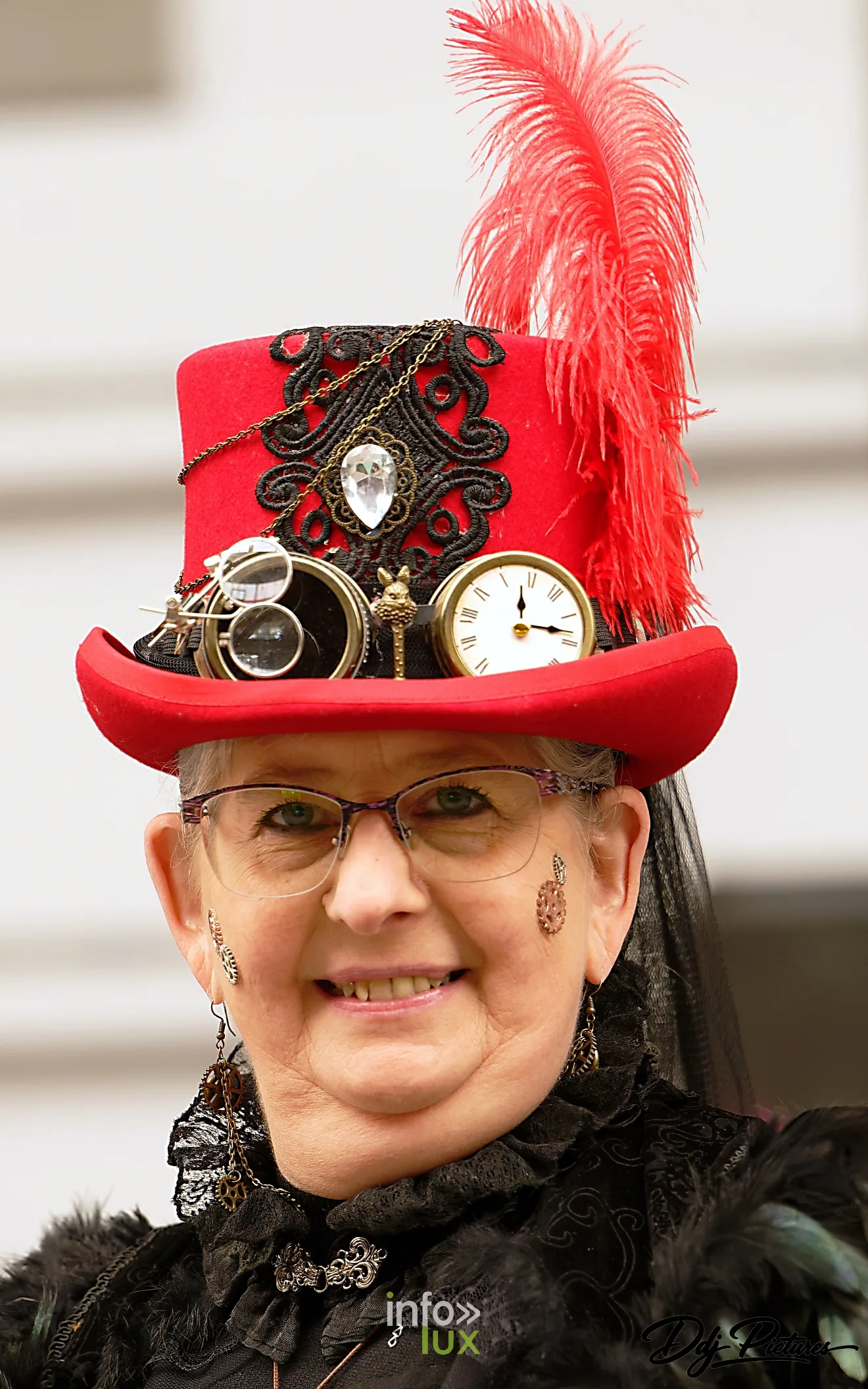 Participante en haut-de-forme rouge orné de plumes et d’un cadran de montre, convention steampunk Rouages intemporels à Toul, octobre 2026 (photo Éric Didierjean)