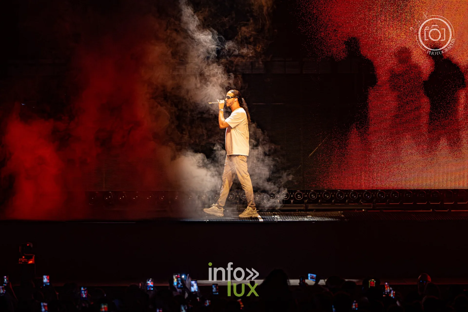 L’un des deux rappeurs du duo Djadja & Dinaz dans la fumée, silhouettes à l’écran, concert de Djadja & Dinaz au Galaxie d’Amnéville, 26 septembre 2026