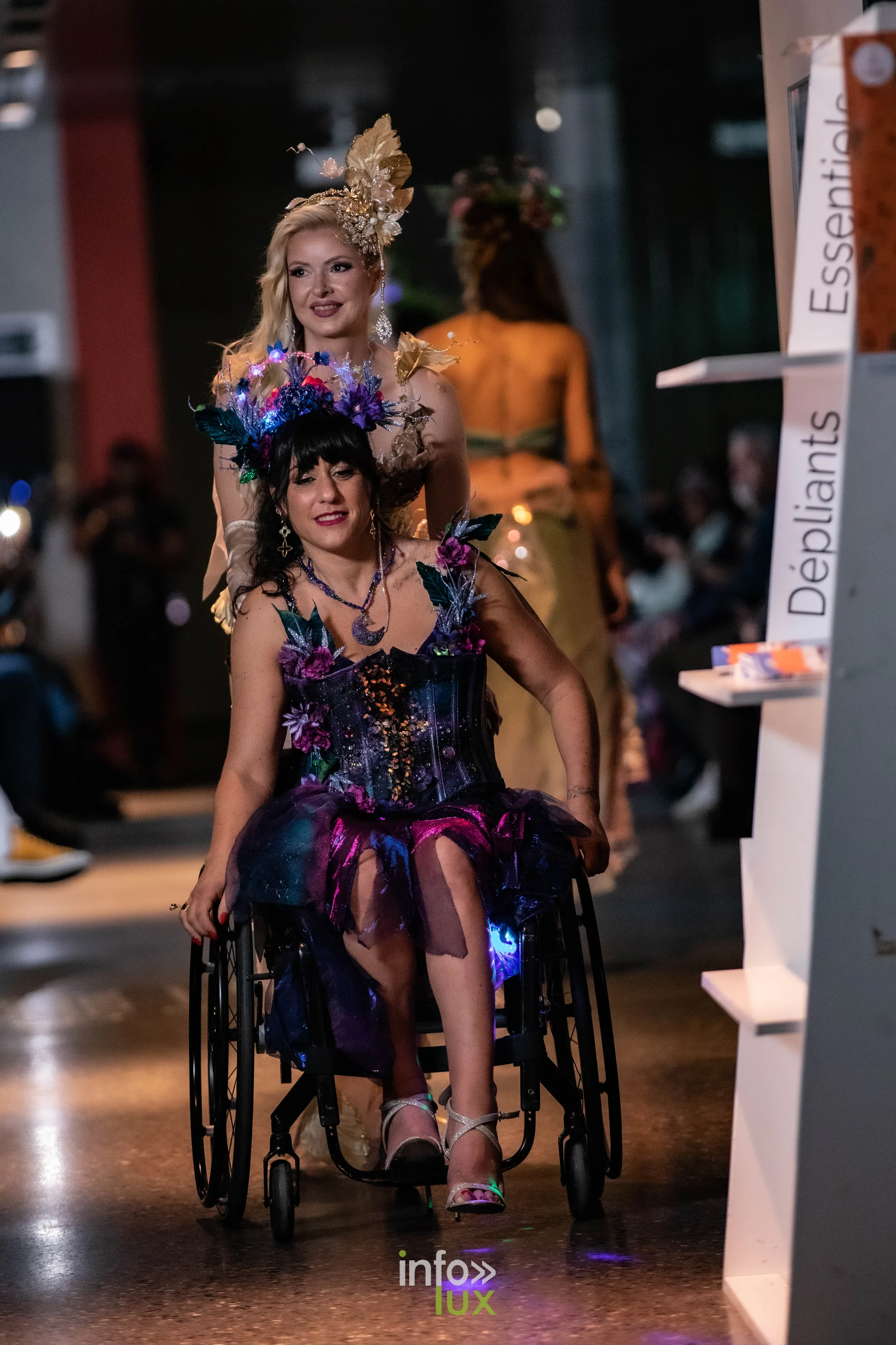 Liège Fashion Week 2026 au Musée Grand Curtius à Liège : mannequin en fauteuil roulant en robe violette fleurie et couronne